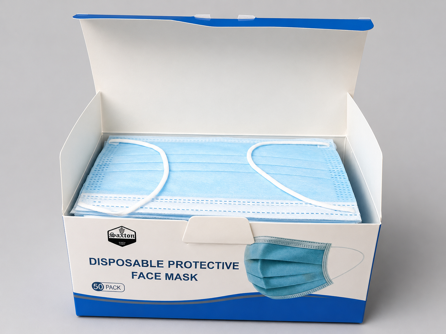 Open Saxton Face Mask box containing neatly stacked light blue disposable 3-layer face masks with soft elastic ear loops, packaged in a 50-count dispenser box.