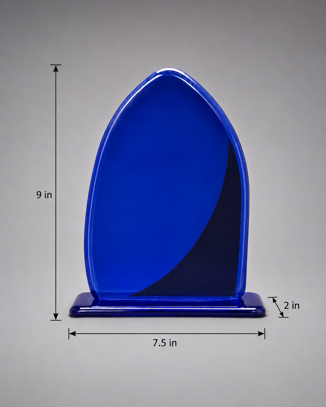 Back side of A modern abstract glass award plaque featuring a vibrant cobalt blue color with a textured metallic silver wave design, mounted on a matching blue base against a neutral gray gradient background. Measurements: 9 inches height, 7.5 inches length, and 2 inches width