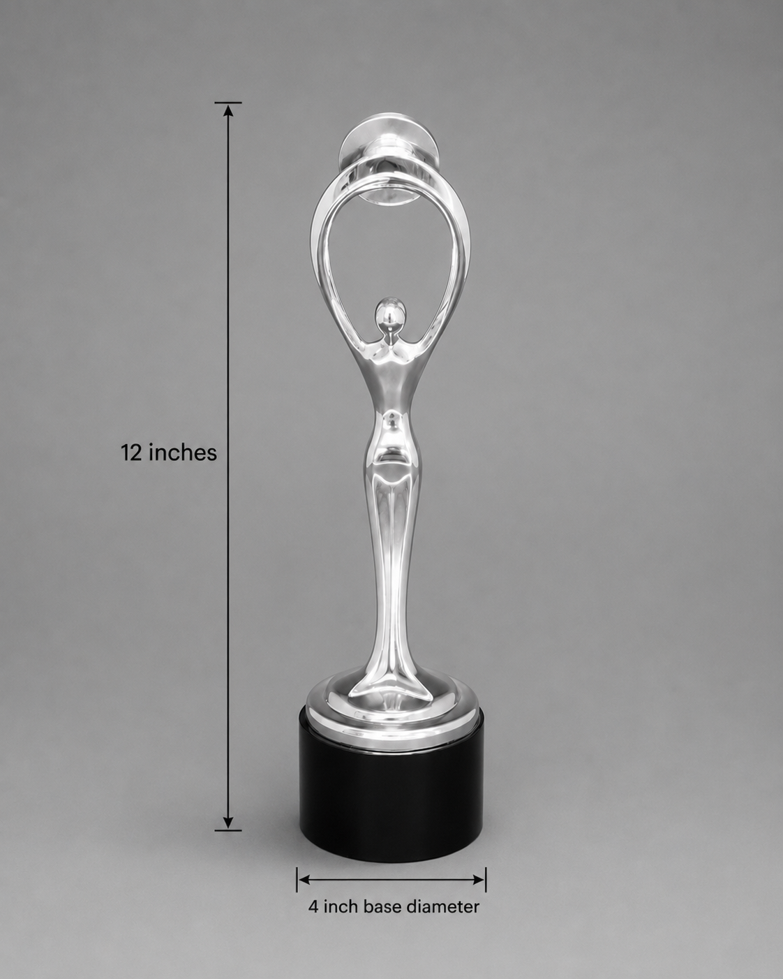 A silver-toned decorative trophy or award holder with a black cylindrical base, shown on a gray background with overlaid dimension lines reading 12 inches tall and 4 inch base diameter.