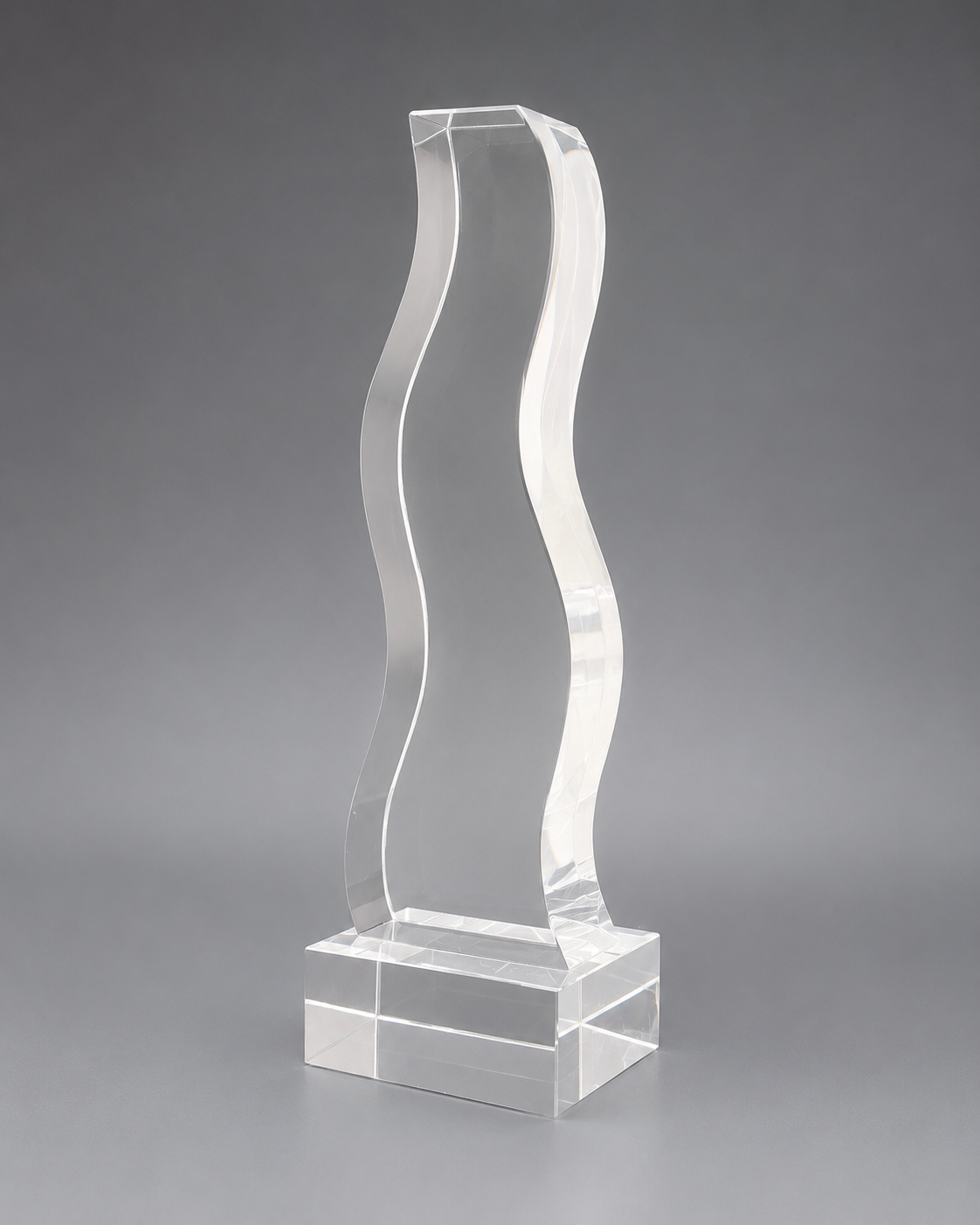 Clear wave-shaped crystal recognition piece on a silver-transparent rectangular base, shown at a three-quarter angle.