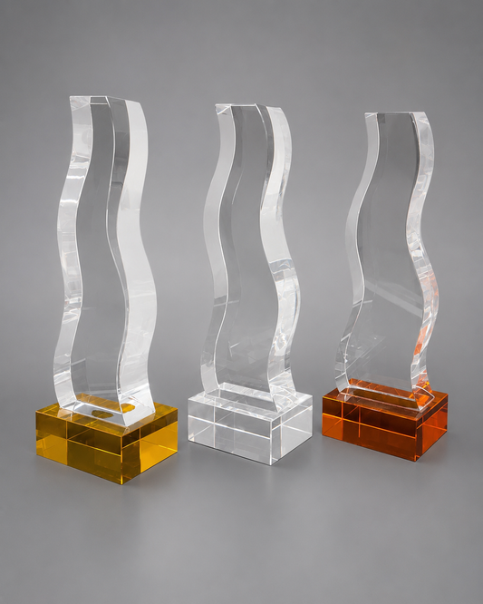 Three matching wave-shaped crystal recognition pieces displayed with Gold/Yellow, silver/clear, and Bronze/Orange rectangular bases.