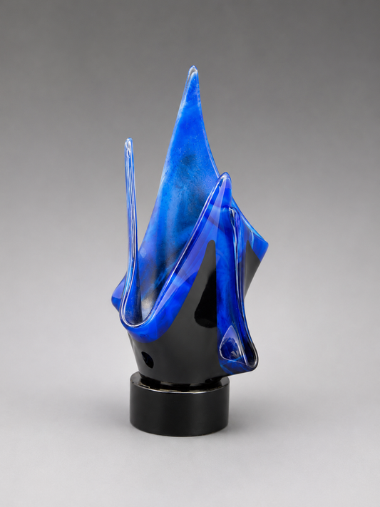 Front view of blue and black exotic flame designed vase on a black stand.