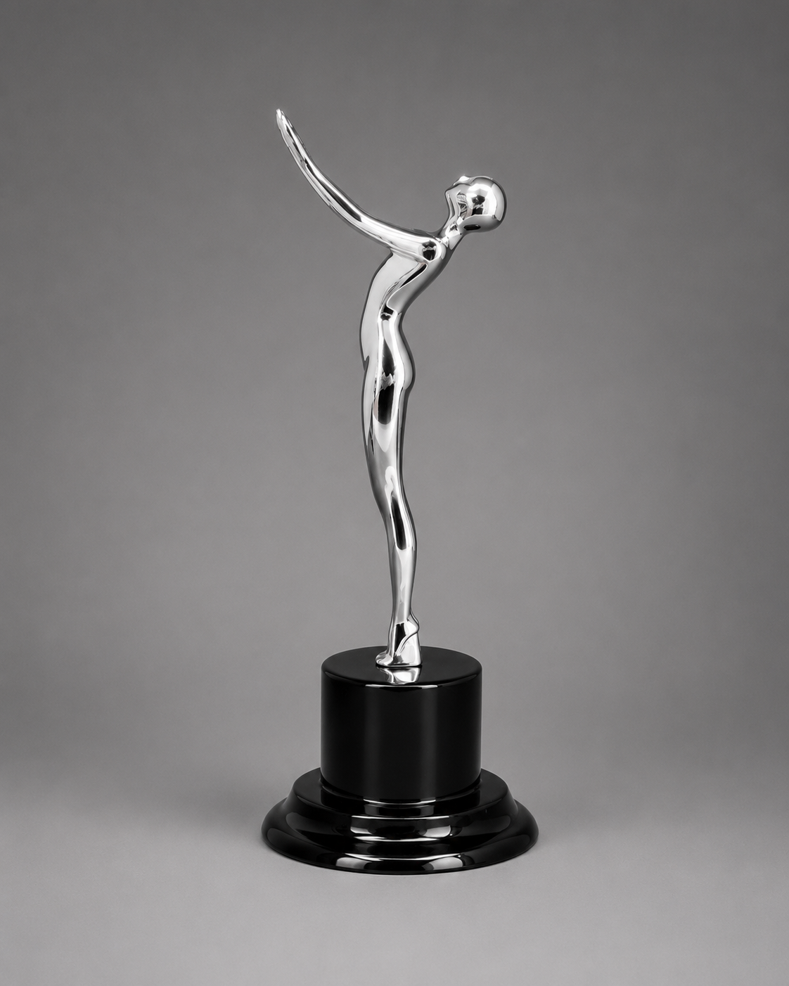 Angled view of the silver Victory Motion Trophy featuring a polished chrome finish and elegant modern design.