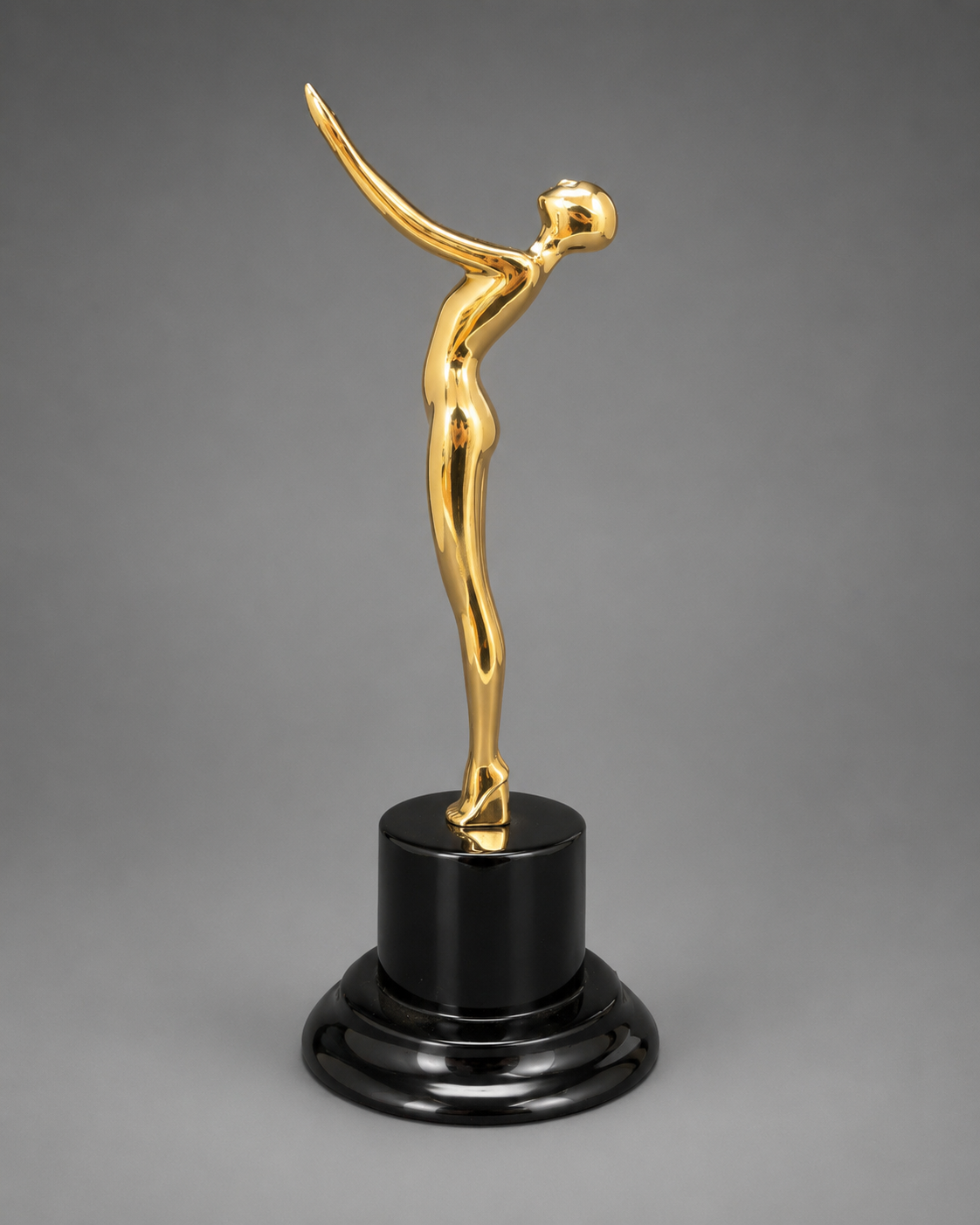 Angled view of the gold Victory Motion Trophy featuring a polished metallic finish and glossy black pedestal base.