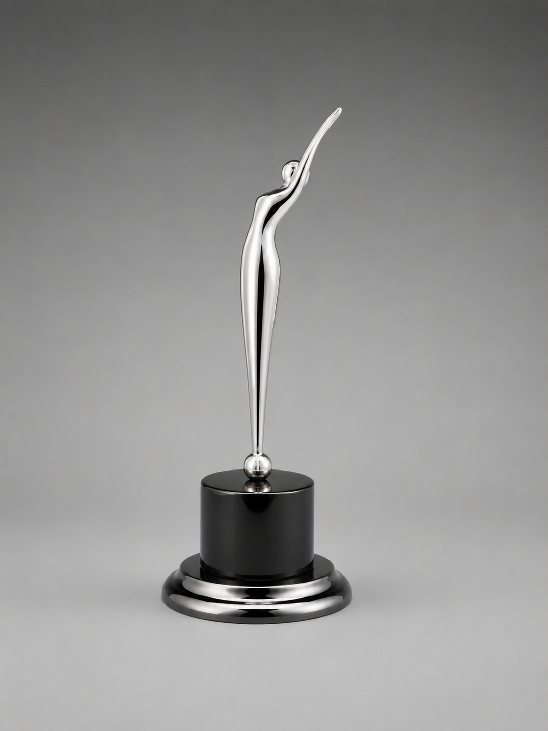 Modern silver abstract achievement award featuring a sleek raised-arm figure on a glossy black pedestal base against a neutral gray background.