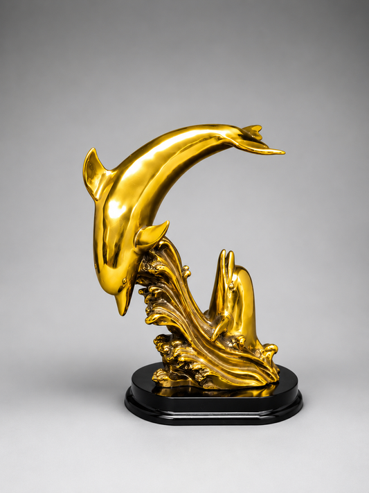 Gold dolphin sculpture on a gray background