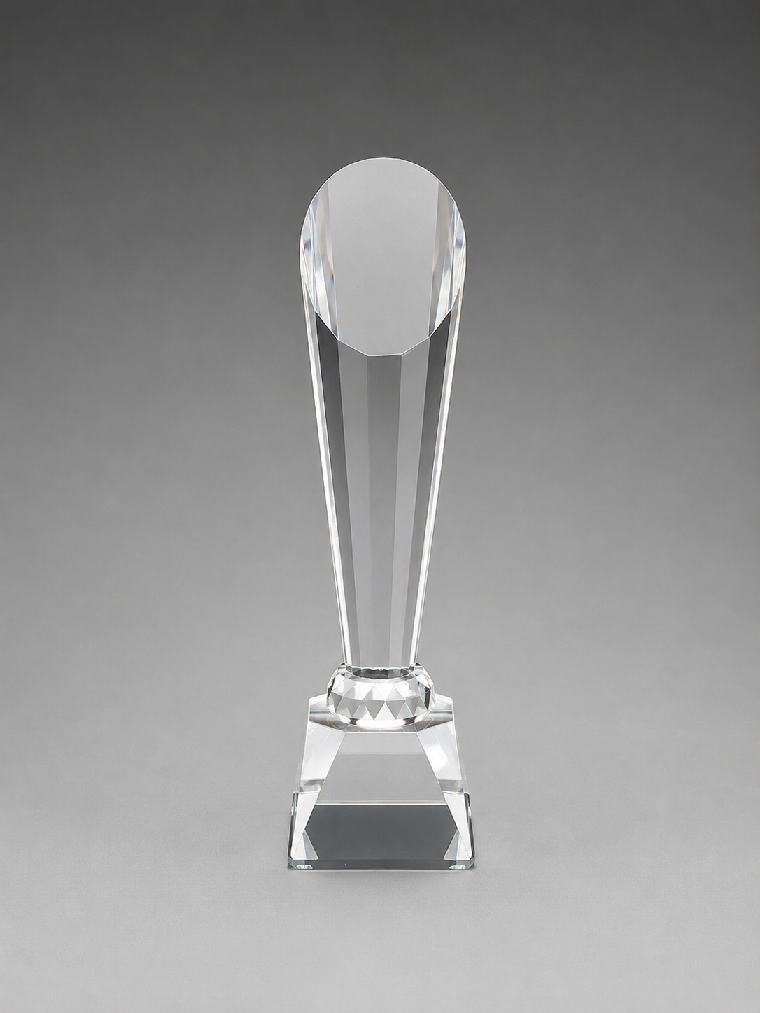 Clear glass trophy on a gray background