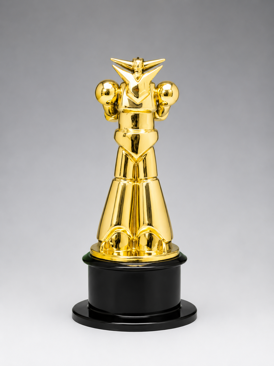 Gold superhero trophy on a black base against a gray background