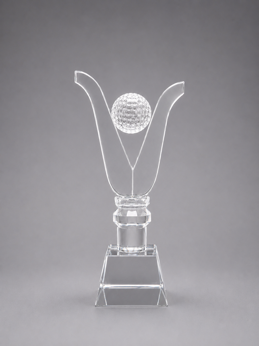 Clear crystal trophy with a golf ball design on a gray background