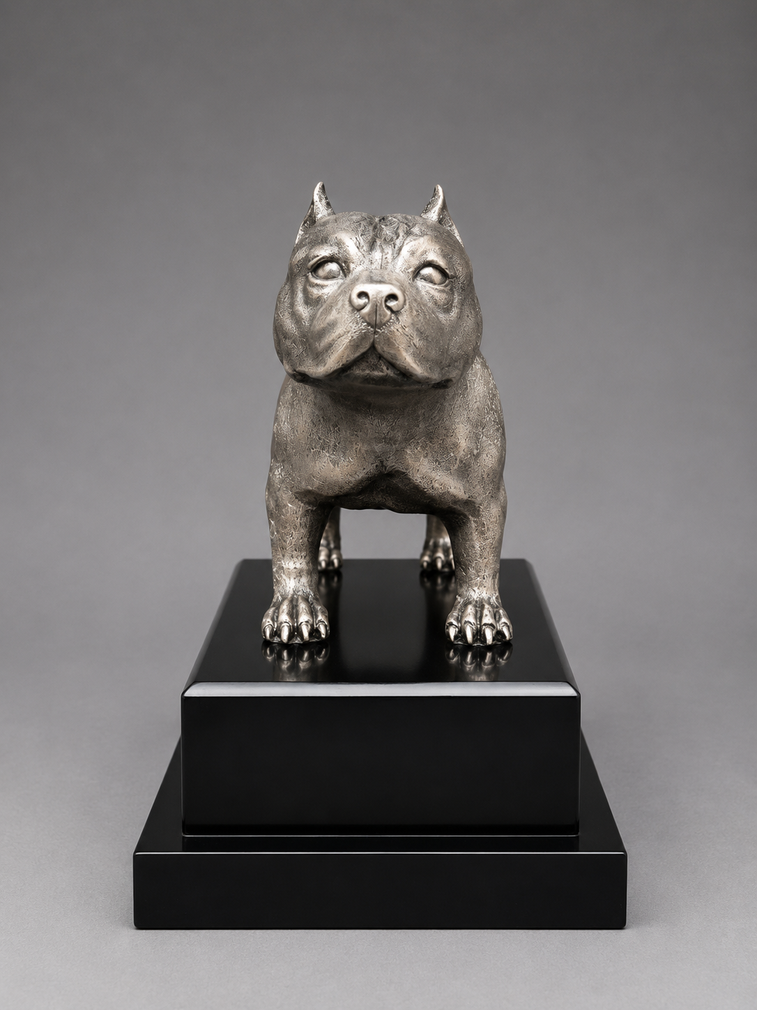 Front view of Silver statue of a bulldog on a black base with 'Texas Bully Bowl' text against a gray background