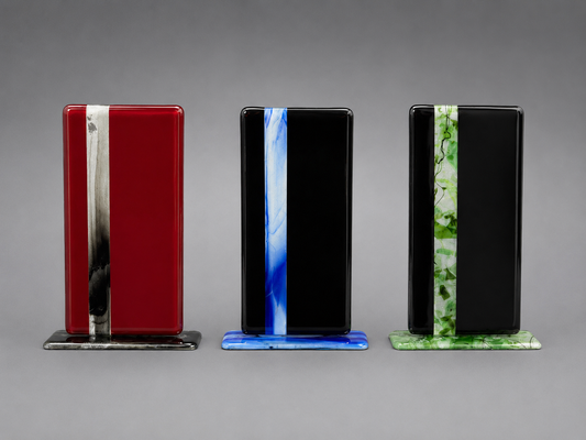 Three rectangular glass plaques with color stripes on a gray background