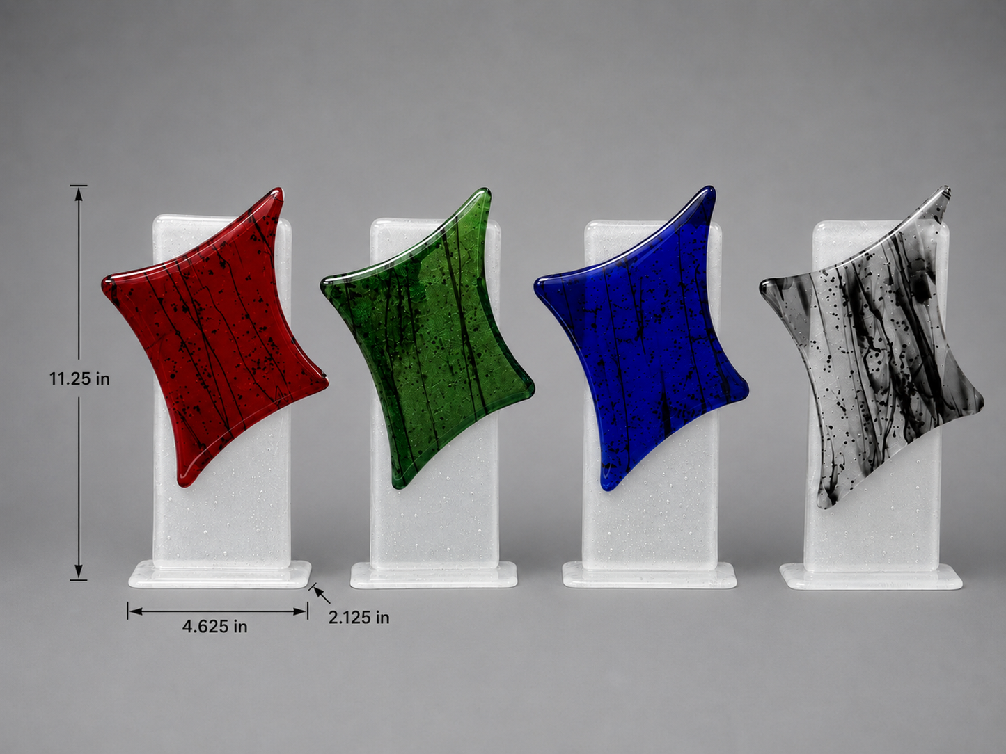 Four colorful geometric sculptures on white stands with measurements against a gray background. 11.25 inches height. 4.625 inches width. 2.125 inches depth.