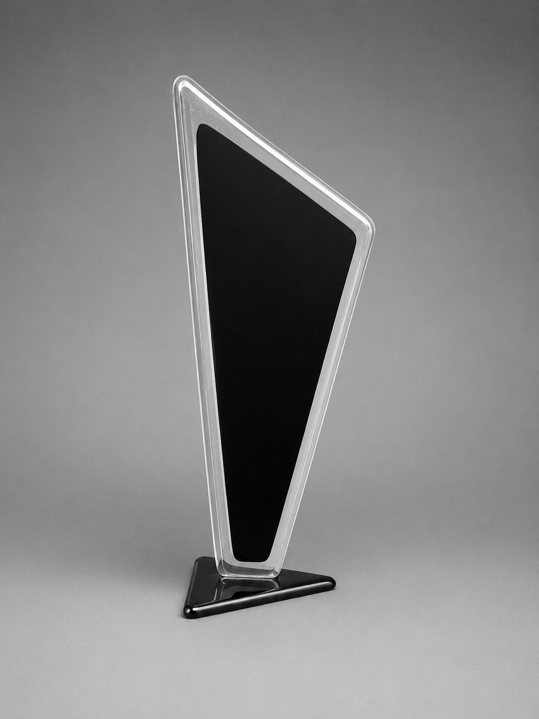 Tall, thin black and silver display plaque against a gray background