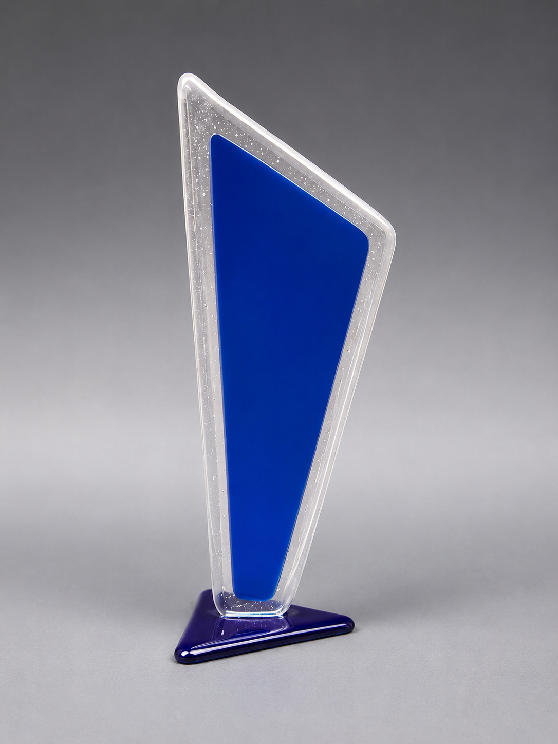 Tall, blue and silver award plaque on a gray background