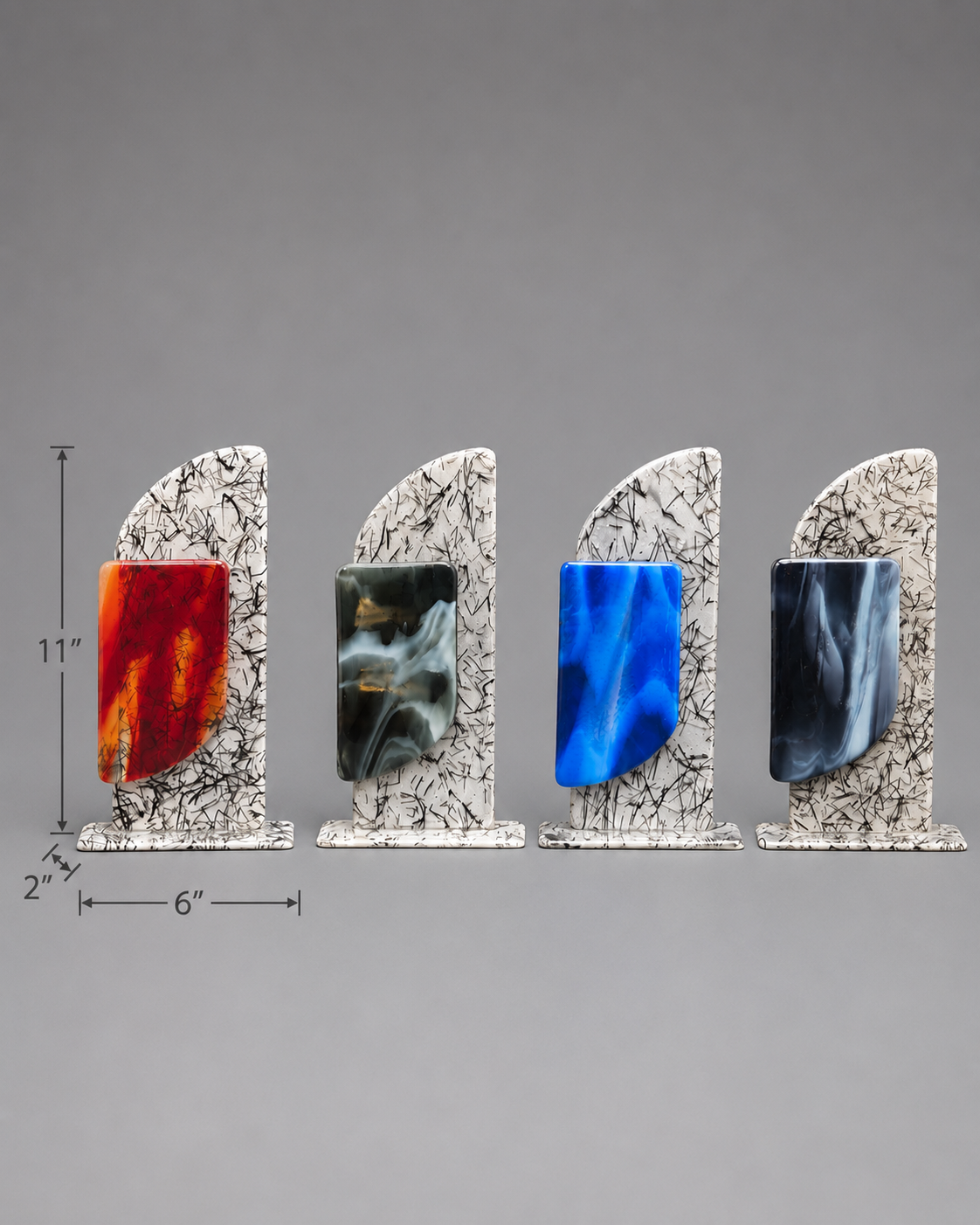 Four decorative glass plaques with white marbled bases and colorful center panels in red, black/gray, blue, and dark gray, shown on a gray background with dimension markings.